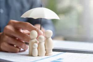 Umbrella over small family figures